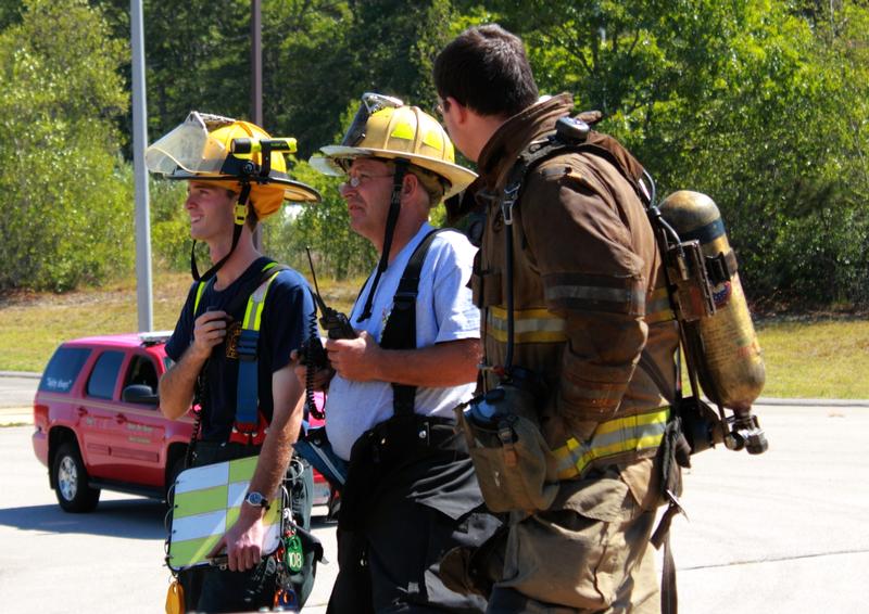 Incident Commander, Lieutenant Koretski confers with Union Fire District Deputy Chief Richard Collinson and Firefighter Doug Perry from Wakefield during live fire training at the Union Fire District Burn Building in September 2013. 